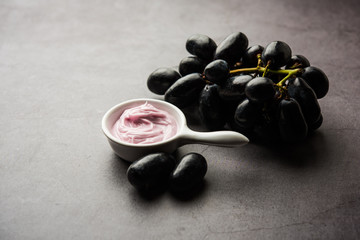 Black grapes, yogurt and honey mix face mask or cream for skin dark spot removal treatment, created using Angoor extract, curd and honey. selective focus