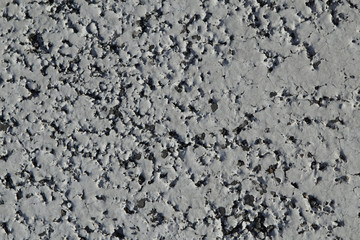 Asphalt painted in white by paint.
