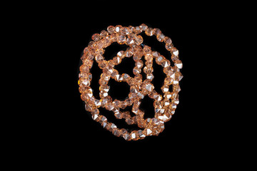 Natural stone beads on a black background isolated