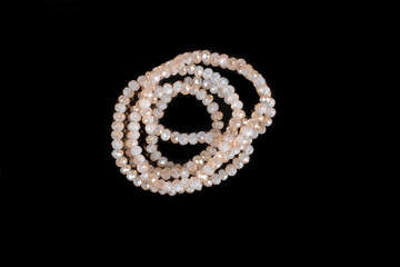 Natural stone beads on a black background isolated