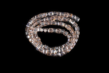 Natural stone beads on a black background isolated