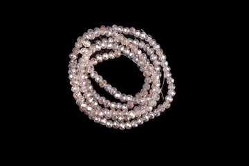 Natural stone beads on a black background isolated