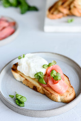 Toast with salmon, poached egg and basil. Morning and Breakfast. Healthy nutrition. Selective focus