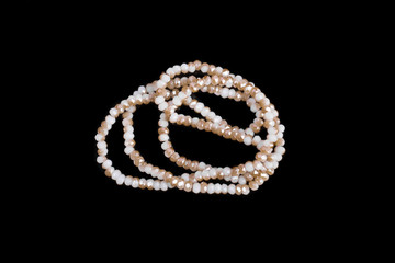 Natural stone beads on a black background isolated