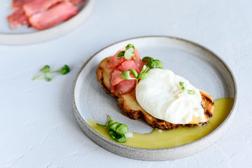 Toast with salmon, poached egg and basil. Morning and Breakfast. Healthy nutrition. Selective focus