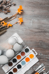 easter eggs and colorful paints and brush with yellow flowers