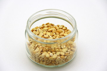 Glass jar with peas on a white background, top view