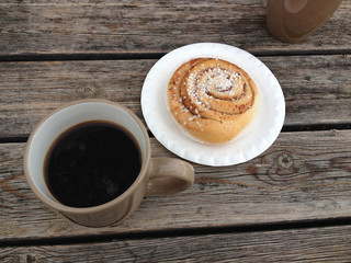 Swedish bun and coffee on wooden table