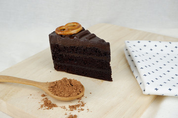 Close up view of sliced chocolate cake on top with pretzel