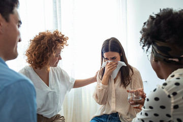 Multi-ethnic group of people in counseling session with therapist. Therapy crisis. Depressed woman...
