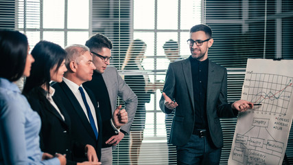 project Manager pointing to a flipchart with a schedule