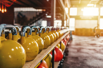 Kettlebells with various colors. Sport equipment in gym. kettlebell on floor background, Fitness...