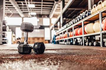 Shot of the interior of a health club full of gym equipment ready for use. Dumbbell and Rope on the...