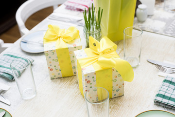 Small gift boxes on a table with bows on them. Box on a table.  J