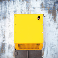 Power generator with a pipe. Yellow power generator.