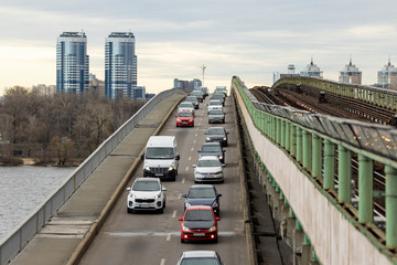 Cars in the morning traffic jam ride on the metro bridge in Kiev.