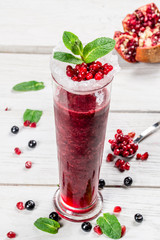 Berry smoothie with mint in a long glass glass