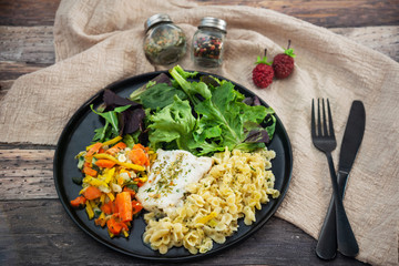 cod fish with vegetables, small vegetables and marine sauce