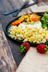 cod fish with vegetables, small vegetables and marine sauce