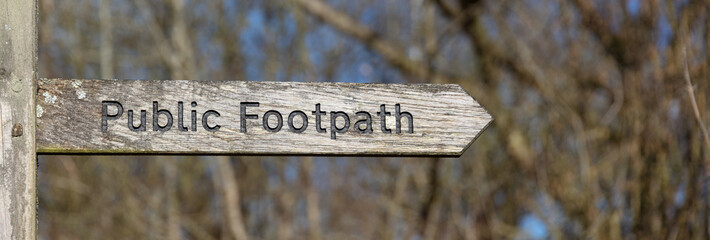 Wooden weathered Public Footpath sign in the Cotswolds, Gloucestershire, England