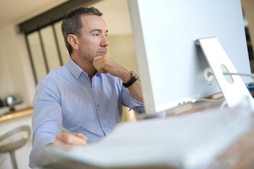 Man in office working on desktop computer