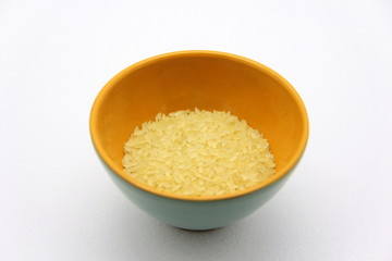 Ceramic bowlwith rice on a white background, top view. The concept of healthy nutrition, diets, vegetarian products. Stock photo with empty space for text and design.