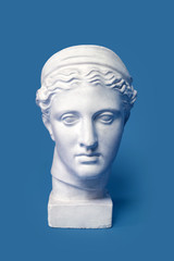 Fototapeta Marble head of young woman, ancient Greek goddess bust isolated on pink background. Gypsum copy of a statue Diana head obraz