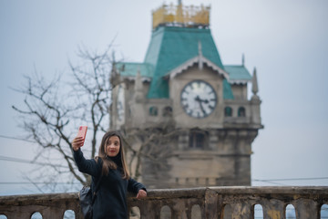 Girl in a black shirt with a clock tower