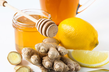Fototapeta na wymiar Tea with ginger, honey and lemon on white background. Isolated. close up