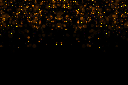 waterfalls of golden glitter sparkle bubbles champagne particles stars on black background,happy new year holiday