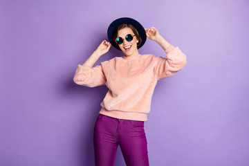 Photo of pretty funny amazing lady rejoicing vacation time good mood wear retro hat sun specs casual pink fluffy pullover trousers isolated purple color background