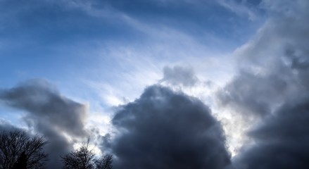 Dark clouds in the blue sky right before a storm