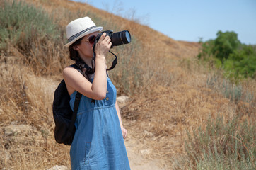 Thin girl takes pictures in the field