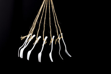 White plastic fork on black background