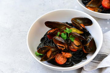 Black spaghetti. Black seafood pasta with mussels. Mediterranean delicacy food. black pasta with cuttlefish ink, recipe Italian food, spanish food. selective focus and copy space