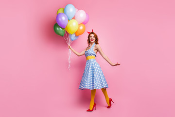 Obraz na płótnie Canvas Full body photo of cheerful dreamy tender gentle pretty girl enjoy anniversary girl lady hold many helium air baloons laugh wear blue polka-dot stockings isolated over pink color background
