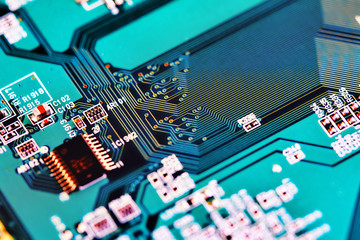 Electronic circuit board with electronic components such as chips close up. Blurry background.