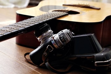 Acoustic classical Guitar and old retro film photo Camera with lens