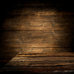 Dark wooden desk of free space for your decoration.Retro wall with copy space for your composition. 