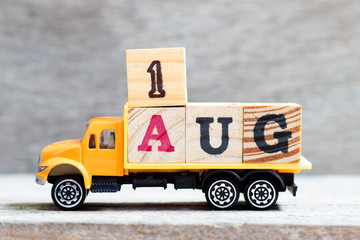 Truck hold letter block in word 1aug on wood background (Concept for date 1 month August)