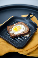 Avocado sandwich with fried egg. Egg on toasted bread for healthy breakfast or snack, copy space. Vegan avocado sandwiche top view close-up