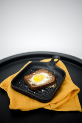 Avocado sandwich with fried egg. Egg on toasted bread for healthy breakfast or snack, copy space. Vegan avocado sandwiche top view close-up