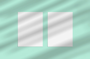 Blank white vertical paper sheet 5x7 inches on light blue background with shadow overlay. Modern and stylish greeting card or wedding invitation mock up.
