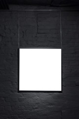 Empty square frame on black brick wall. Blank space poster or art frame waiting to be filled. Square Black Frame Mock-Up