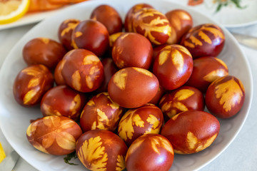 Easter table with large plate of naturally colored eggs. Easter ecological concept.