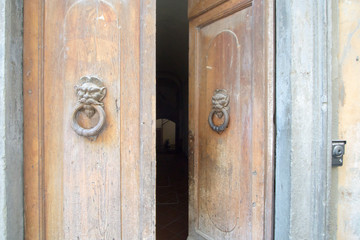 Castelfiorentino is situated in the administrative district of Empoli-Valdelsa, between the Arno River Valley and the Elsa Valley in Italy on July 6, 2019. Old door detail.