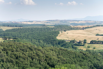Fototapeta na wymiar Castelmuzio, an ancient village dating back to the time of the Etruscans, is built on a volcanic limestone hilltop overlooking an amazing landscape Orcia valley Tuscany Italy on July 2019