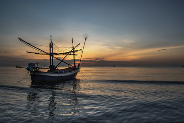 Fototapeta premium Thai fishing boat used as a vehicle for finding fish in the during beautiful twilight in the sea.