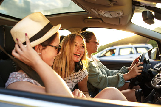 Group of best female friends travel together to summer adventure.They drives a car and making fun.	