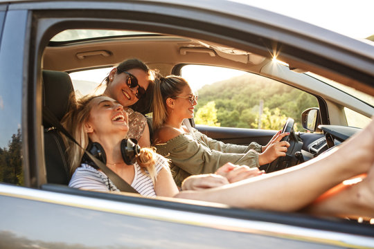 Group of best female friends travel together to summer adventure.They drives a car and making fun.	